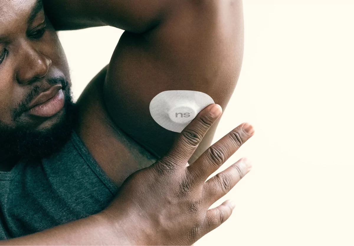 a man wearing a cgm with a NS patch
