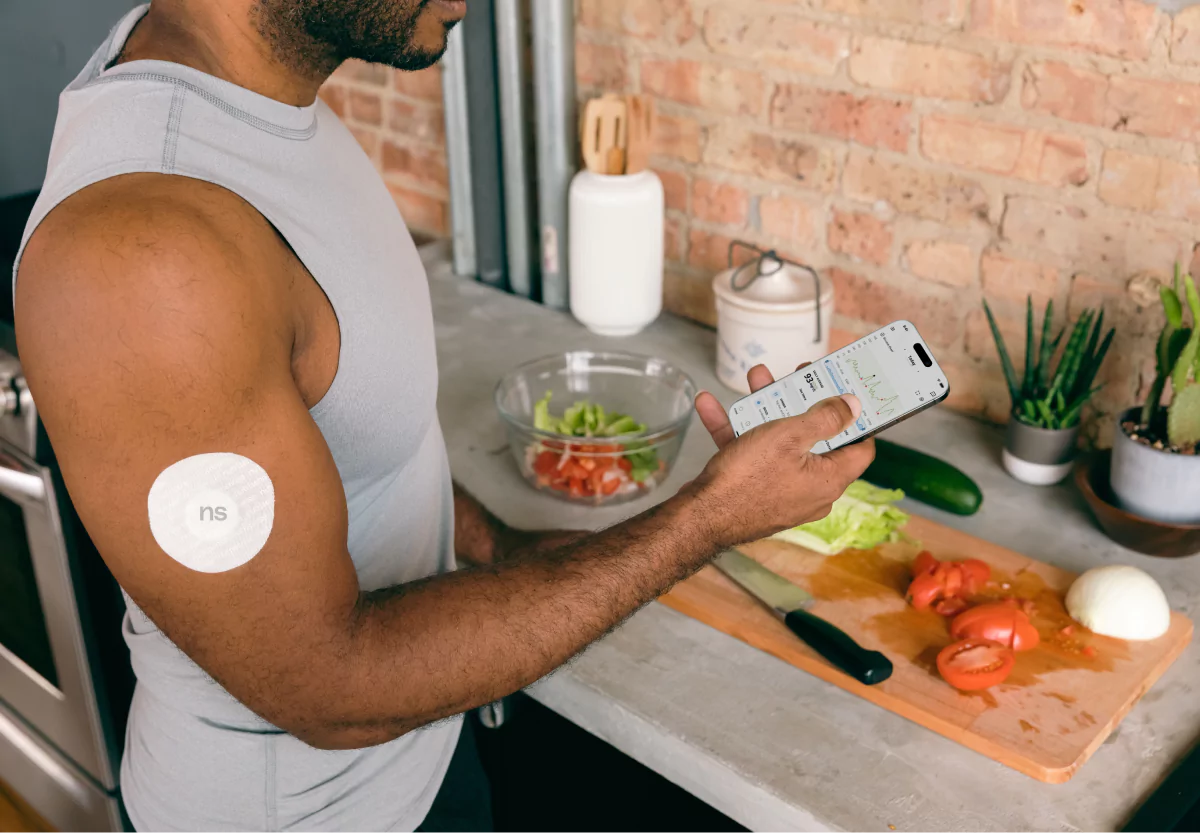 a man logging his meal in the Nutrisense app, wearing a CGM