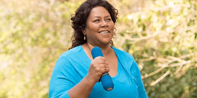 a person holding a dumbbell outdoors