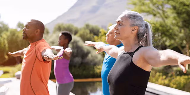 a group of people doing yoga outdoors