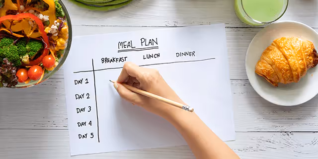 someone writing a meal plan