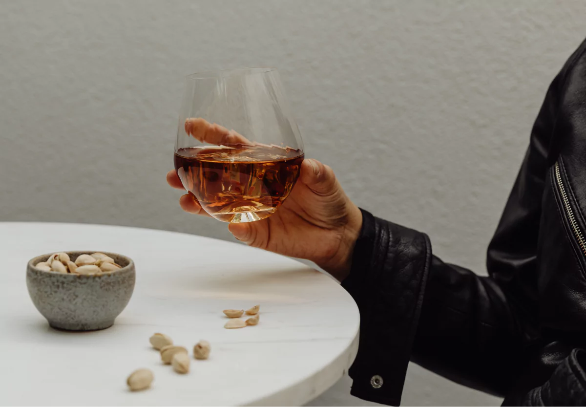 someone drinking a glass of wine