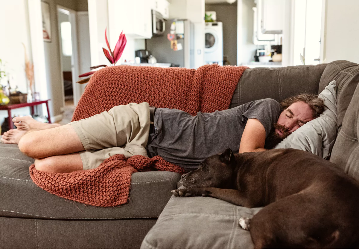 a man laying on the couch asleep