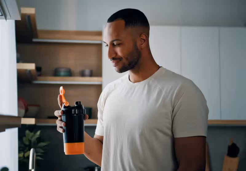 a man drinking a creatine drink