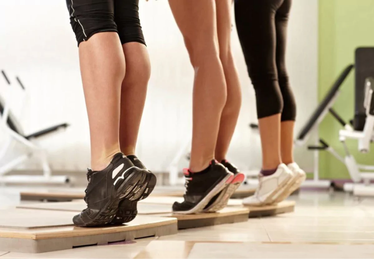 three people doing calf raises