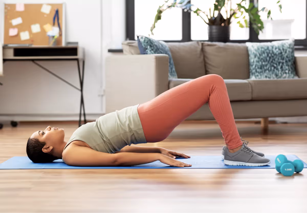 a woman doing glute bridges at home