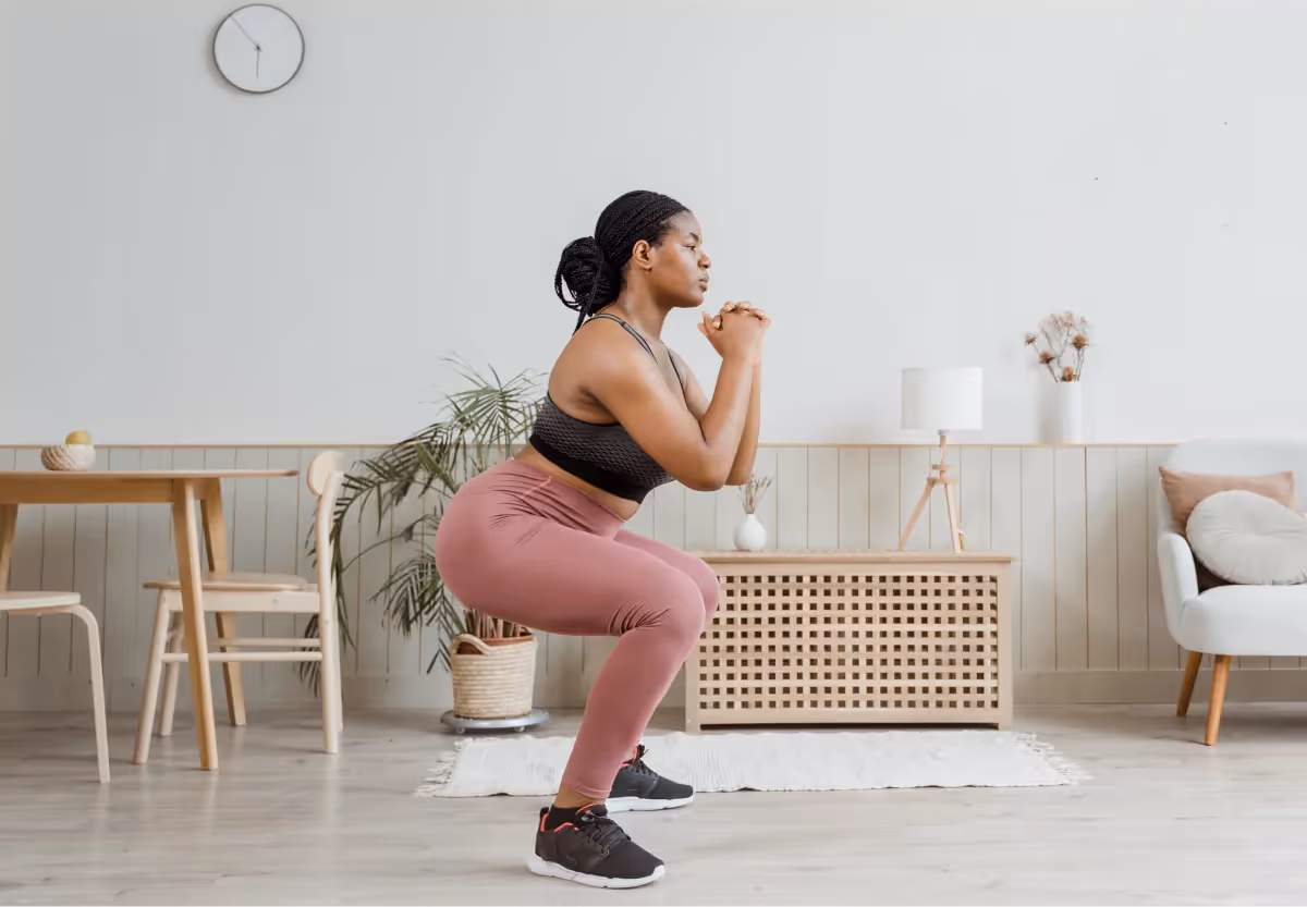 a woman doing a squat at home