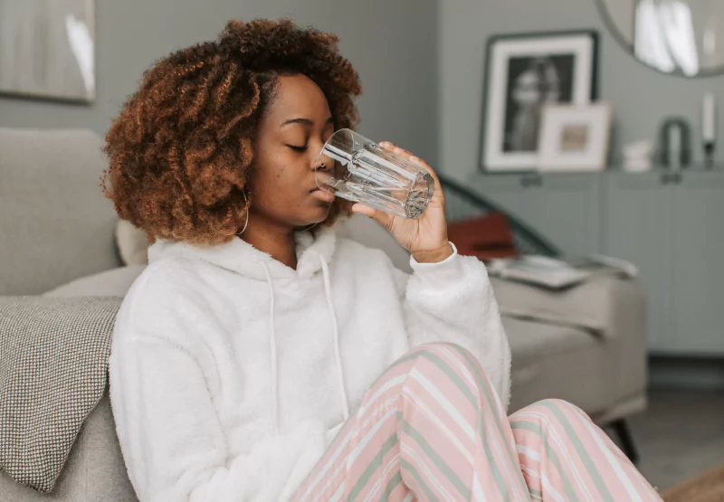 a girl drinking a glass of water