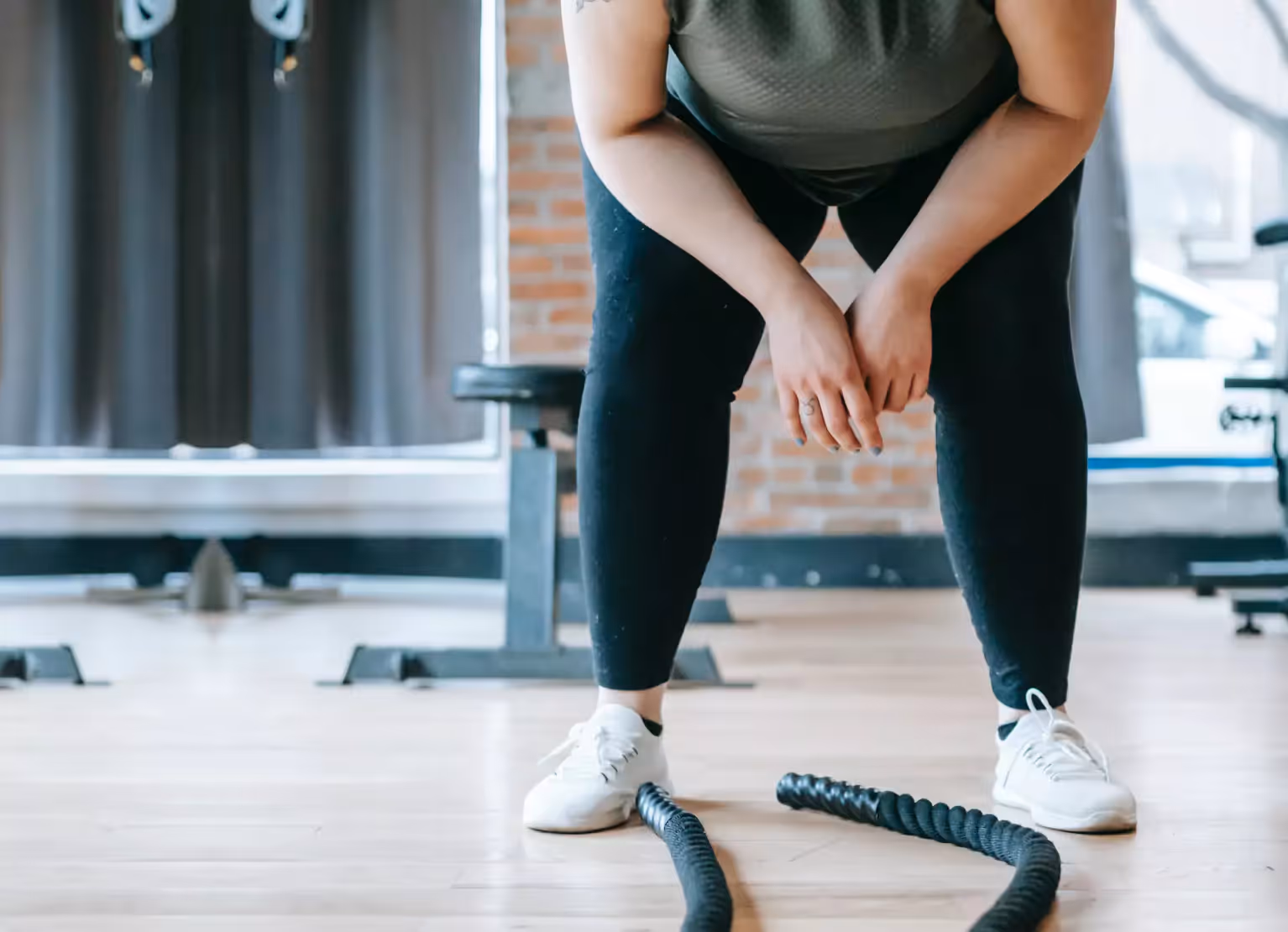 someone bendin over after exercise