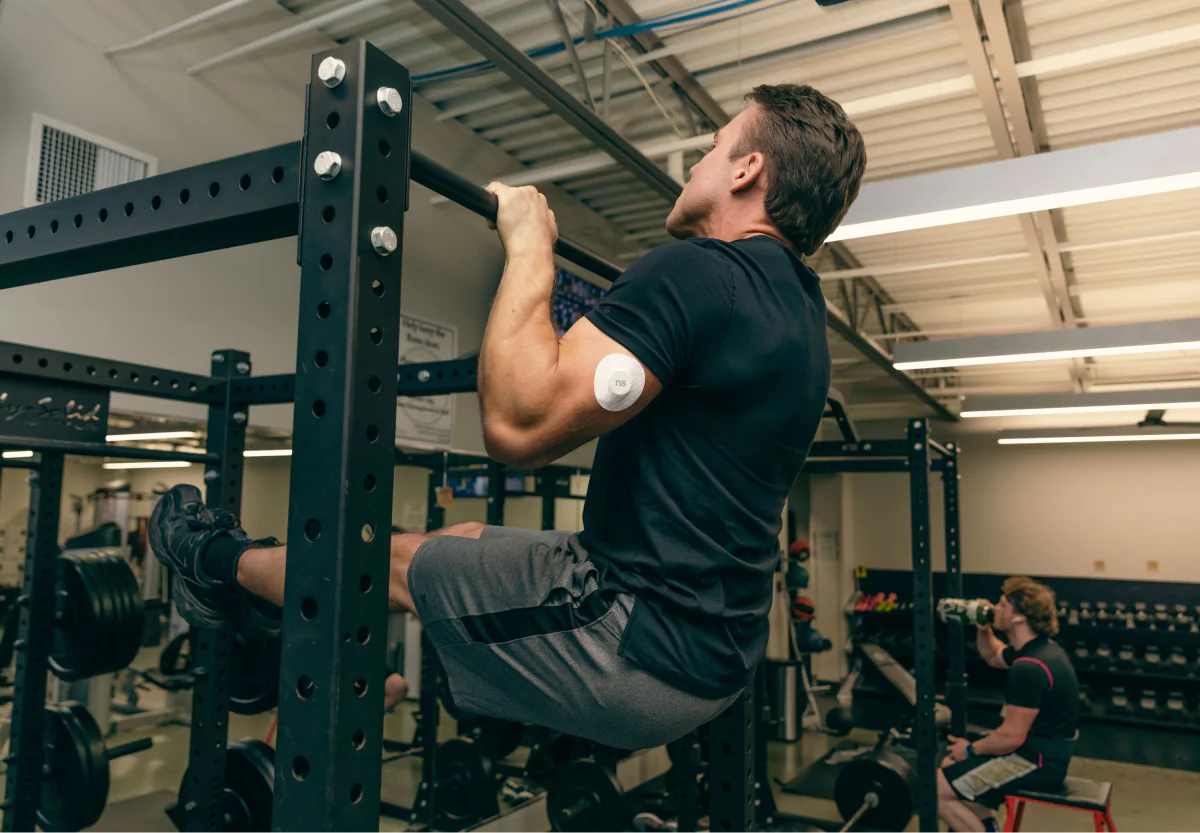 someone doing negative chin ups at the gym