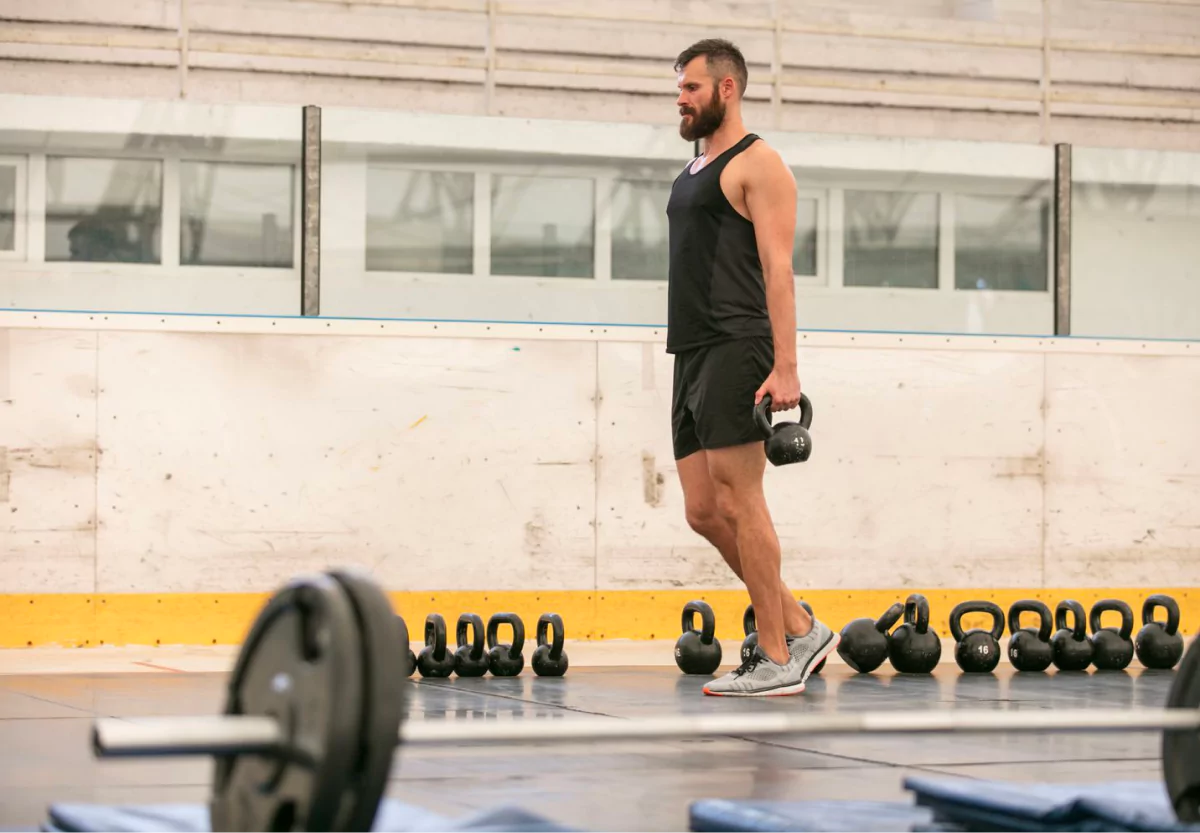 a man doing suitcase carries