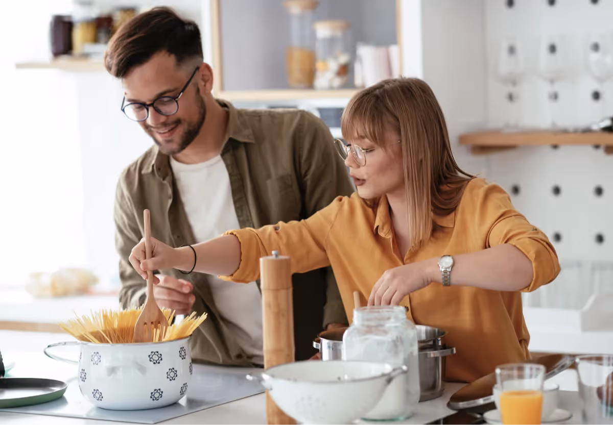 two people cooking together