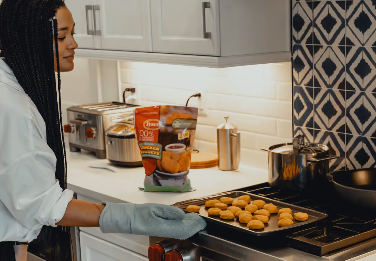 a woman making chicken nuggets at home