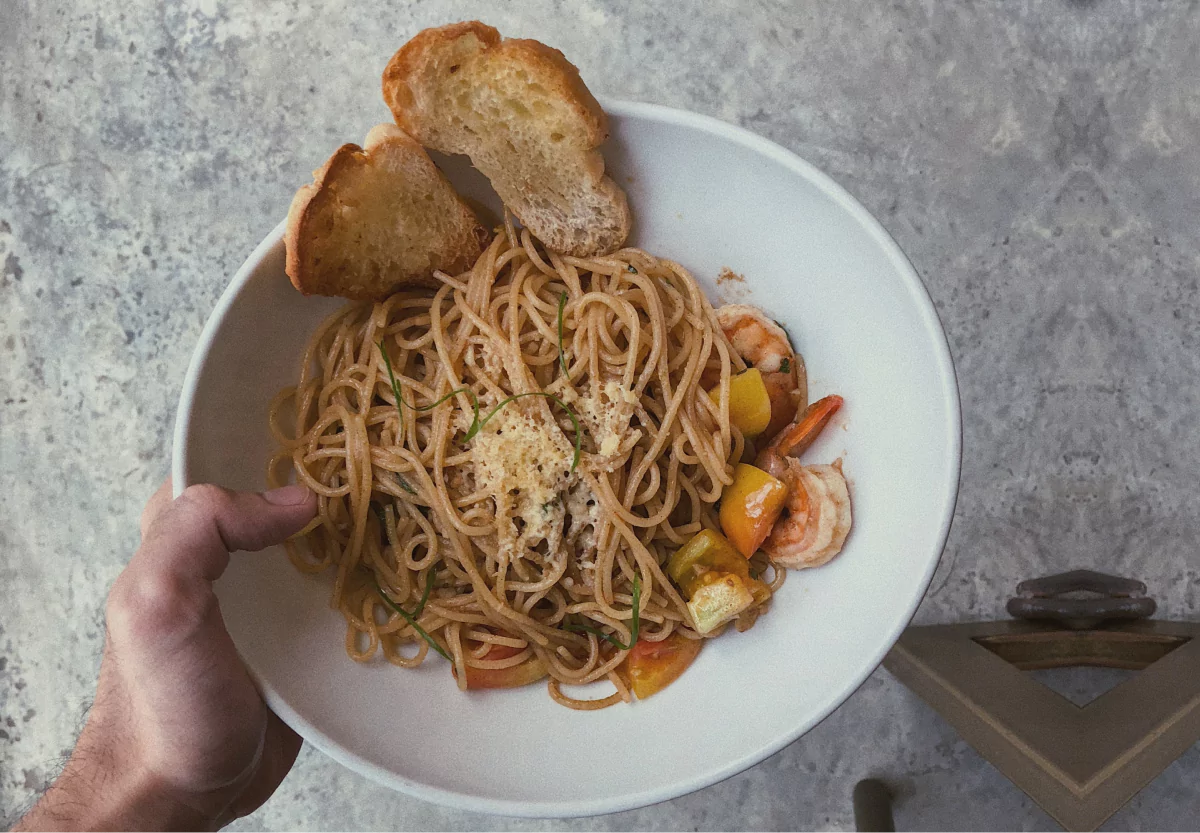 a bowl of pasta and bread
