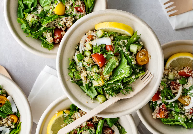 a table with multiple salad bowls