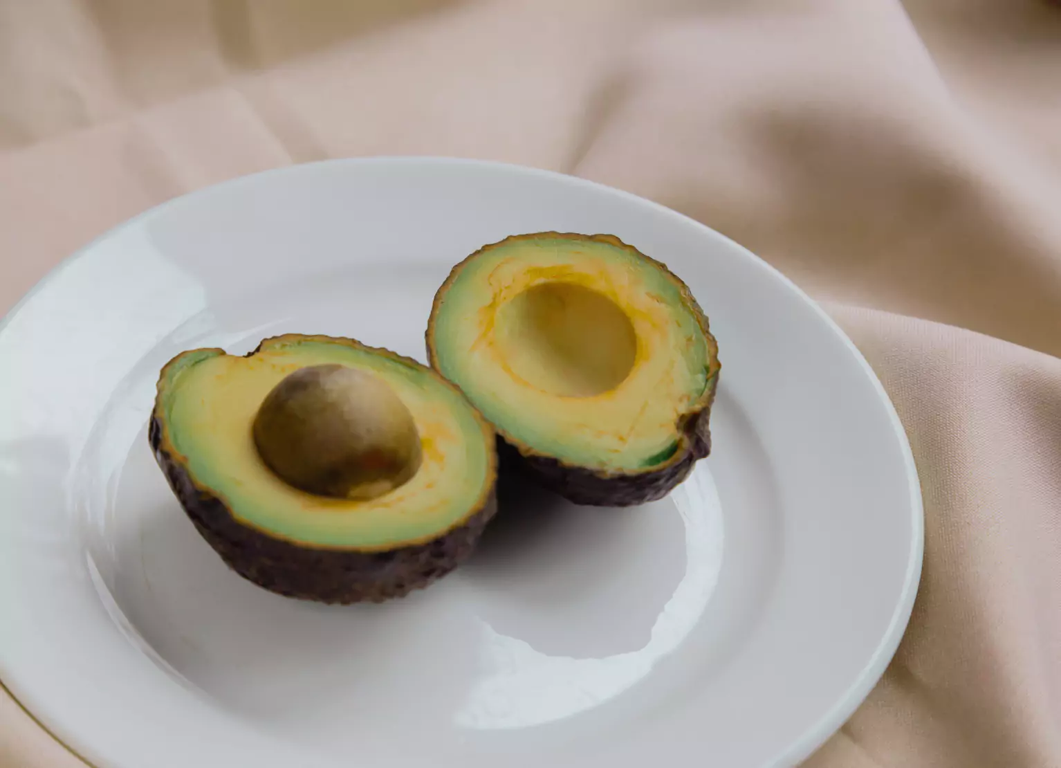 a cut up avocado on a plate
