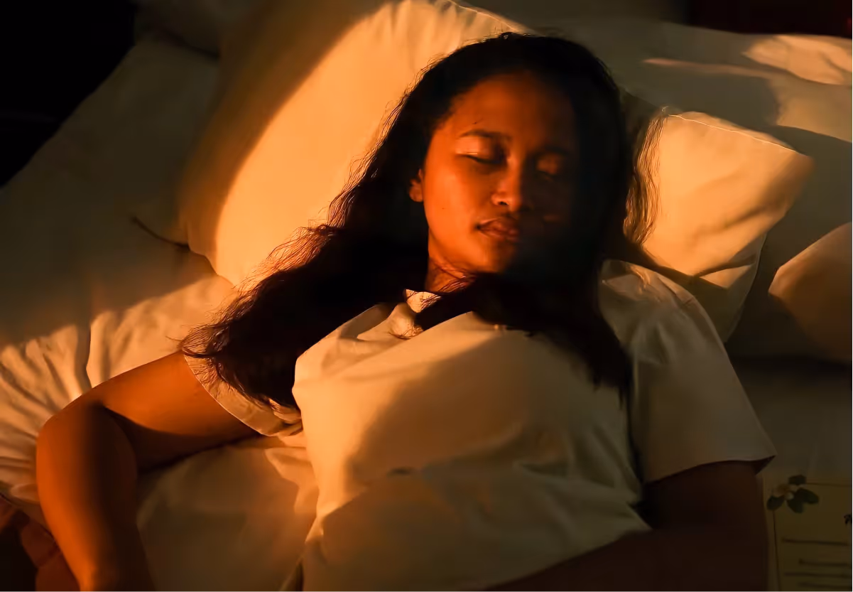 a girl sleeping in her bed