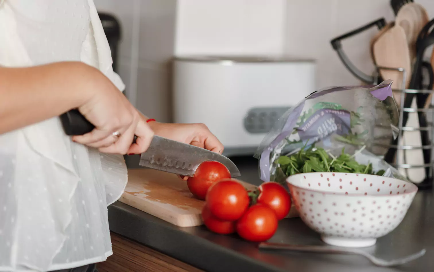 a person cutting tomatoes 