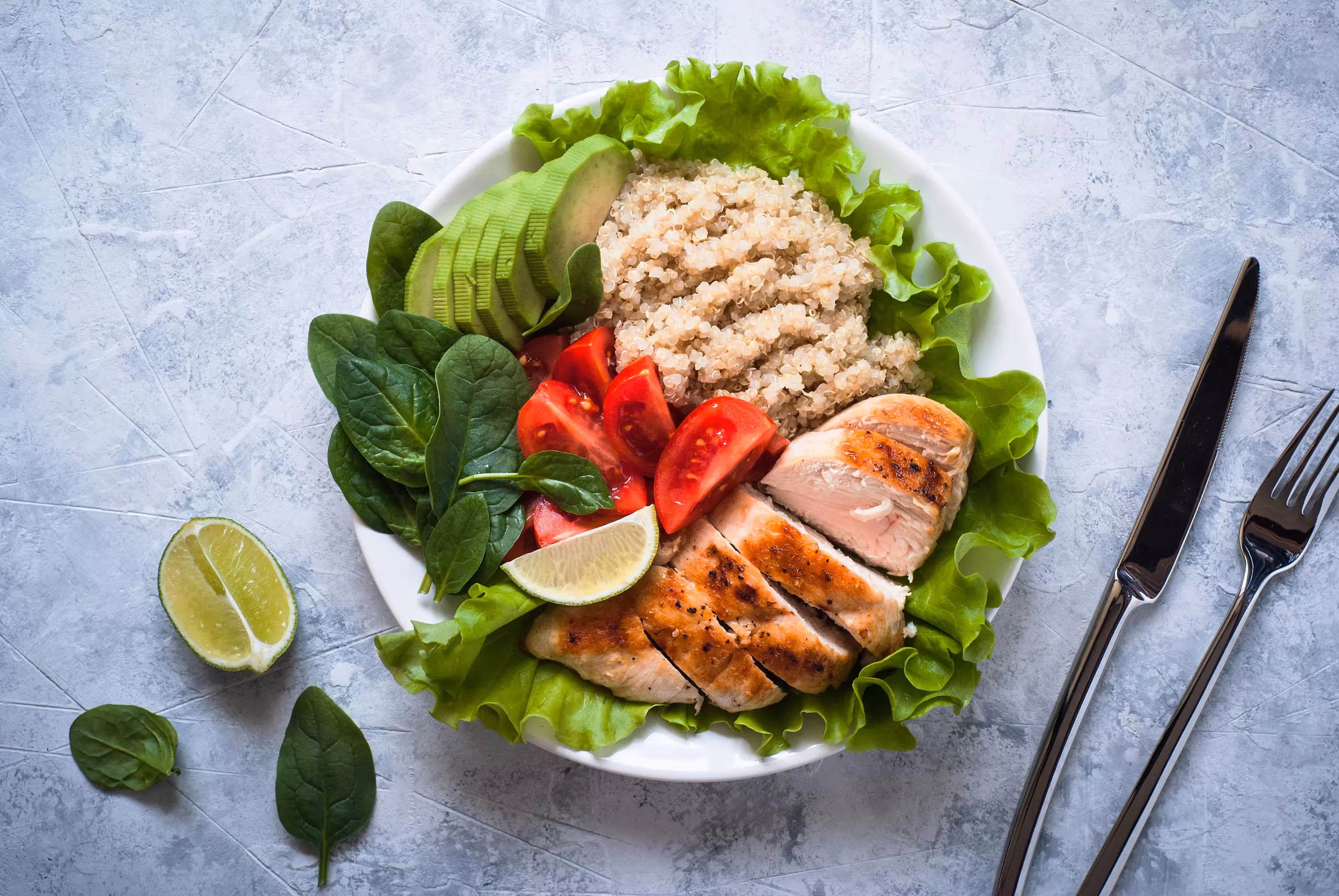 a plate of porridge, chicken, veggies and avocado 