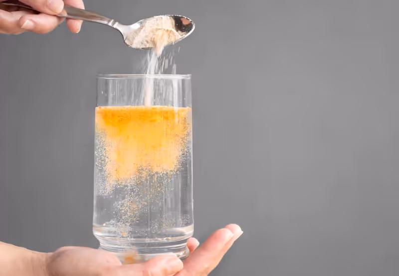 a cup of water with electrolytes being poured in