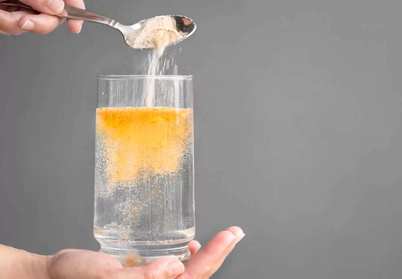 a cup of water with electrolytes being poured in