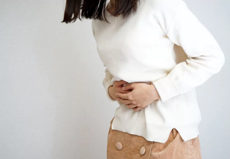 a girl holding her stomach in pain