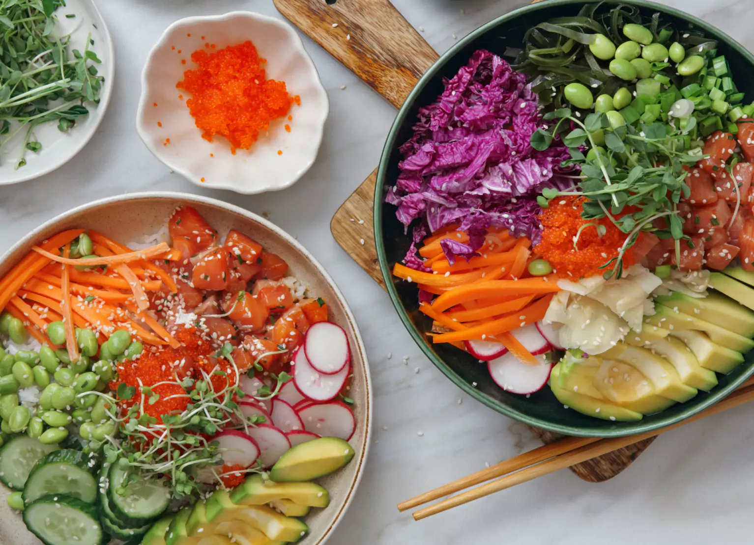 Poke bowls with rice, edamame, purple cabbage, carrots, and leafy greens