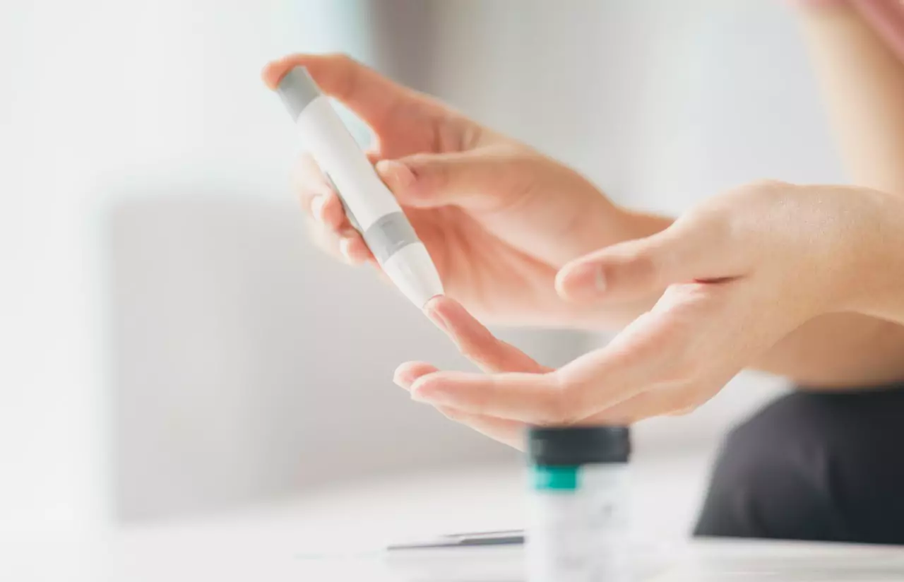 a person using finger prick method to test their glucose level