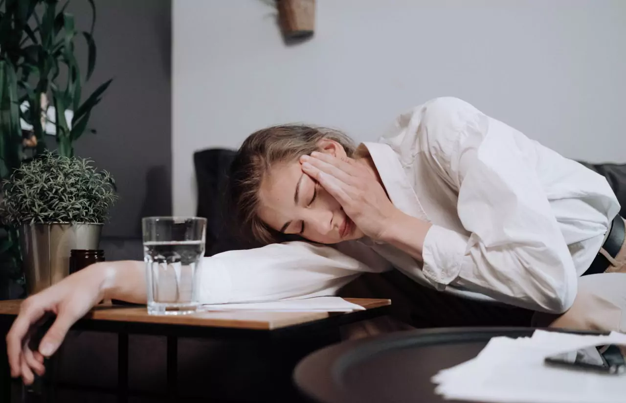 A person asleep near a glass of water