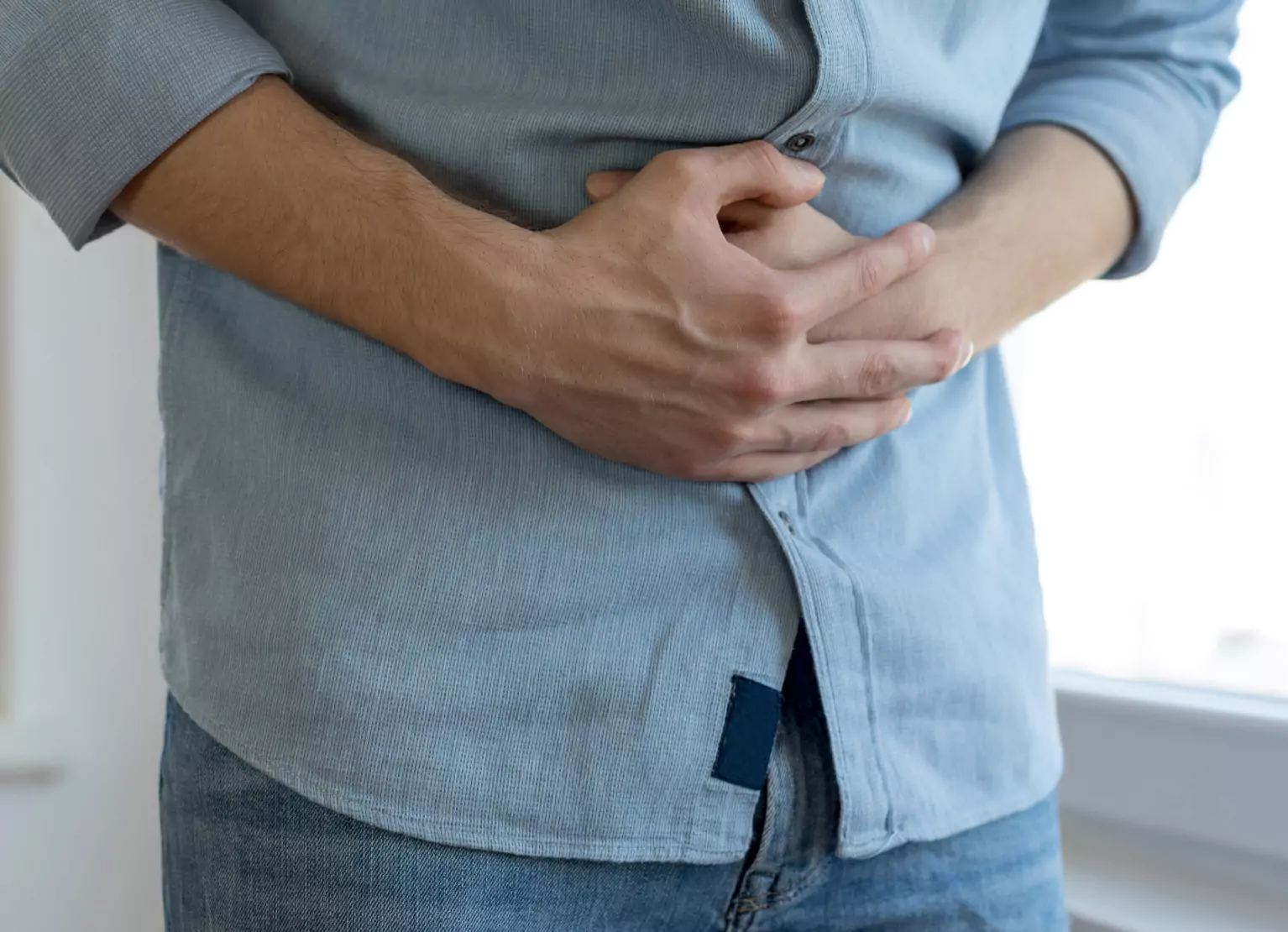 someone holding their stomach in pain