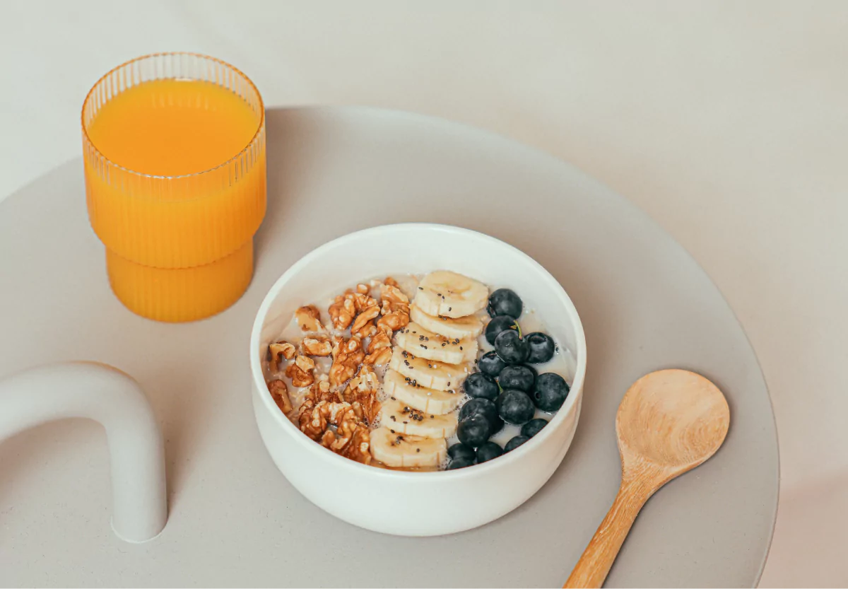 a glass of orange juice and a bowl of oatmeal