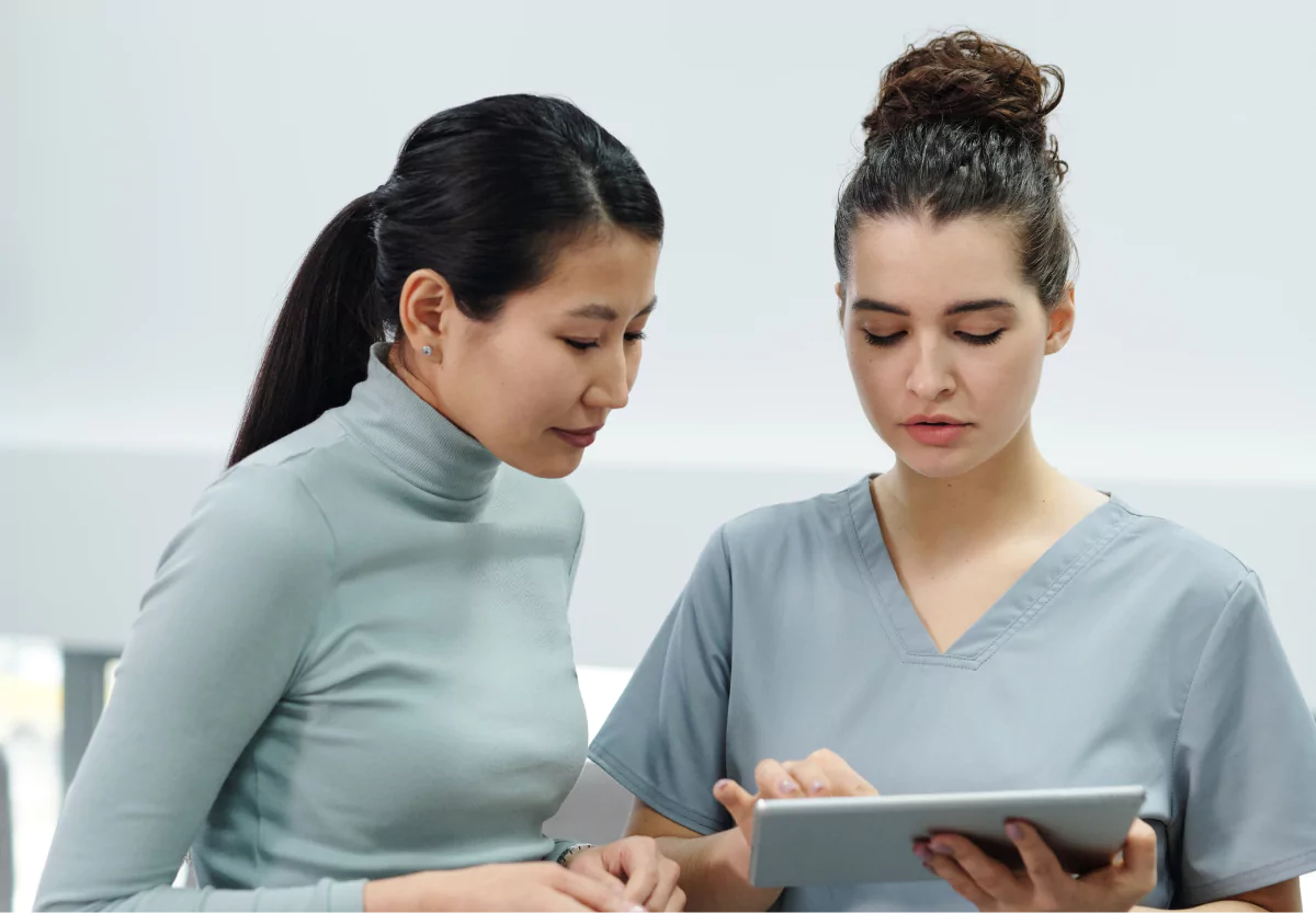 a doctor and her patient reading from an ipad