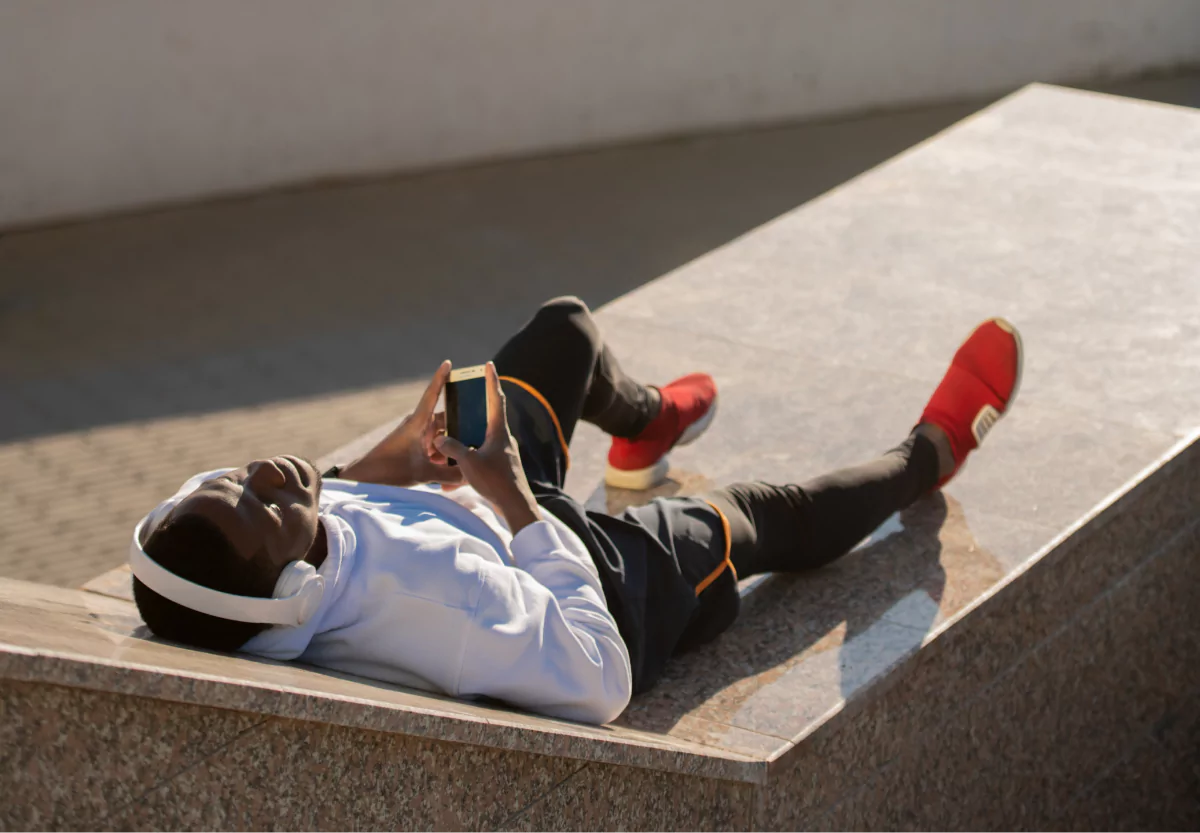 a man laying down looking at his phone