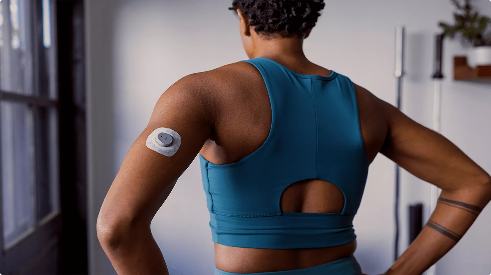 A person scanning a CGM sensor