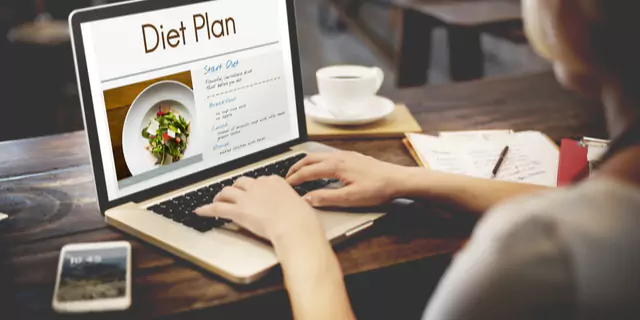 a person writing a diet plan