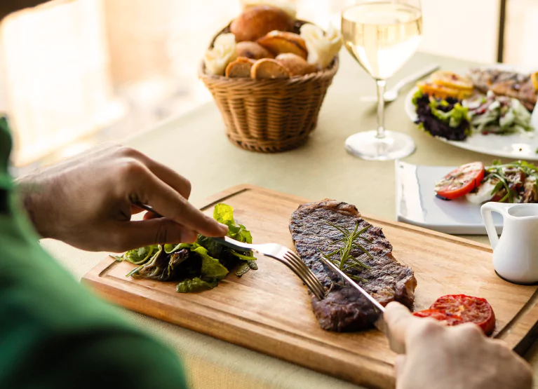 someone cutting into a steak