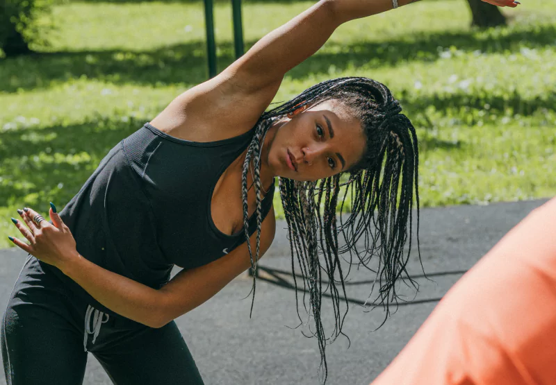 a girl doing stretches in the park
