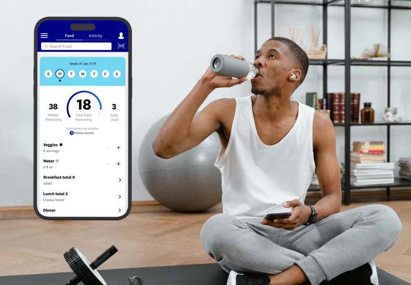 someone using the weight watchers app at the gym