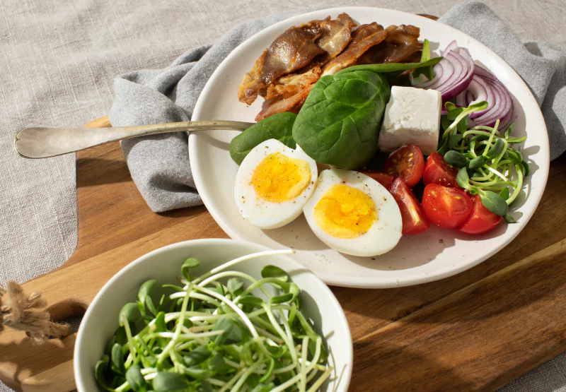 a plate of veggies with an egg