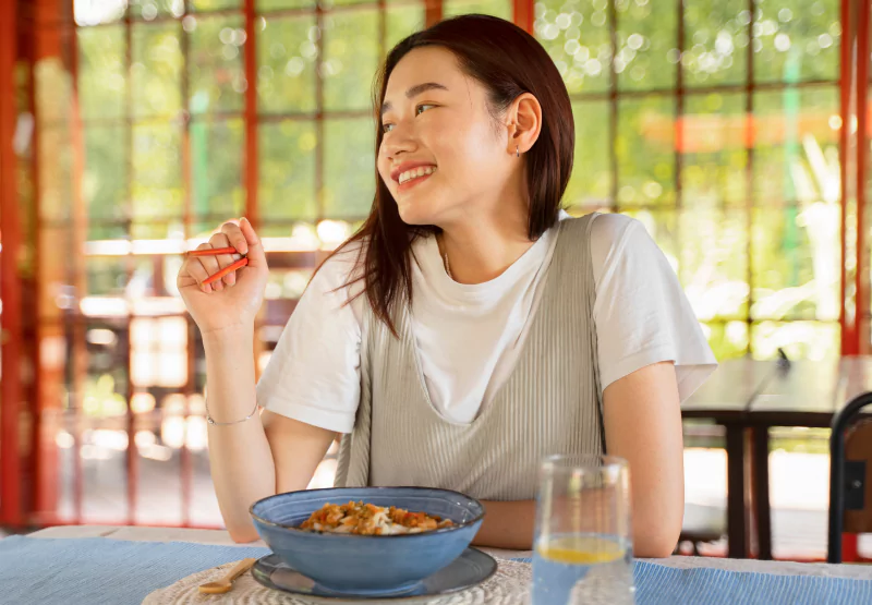 a girl eating a meal and smiling
