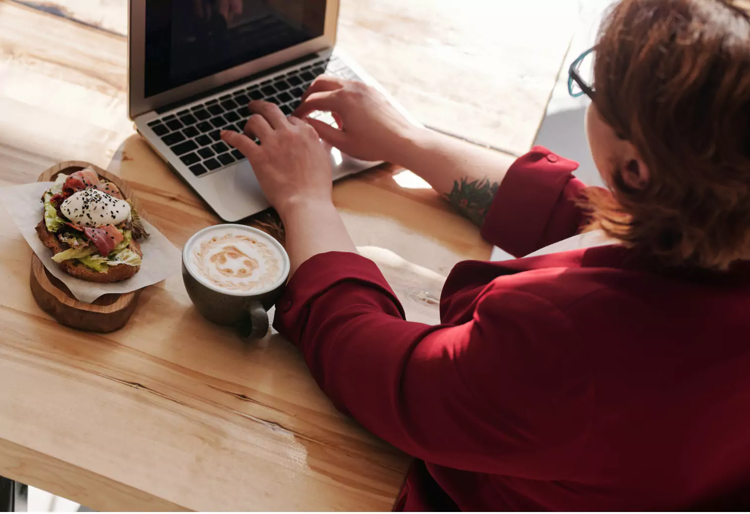 someone working with a toast and coffee