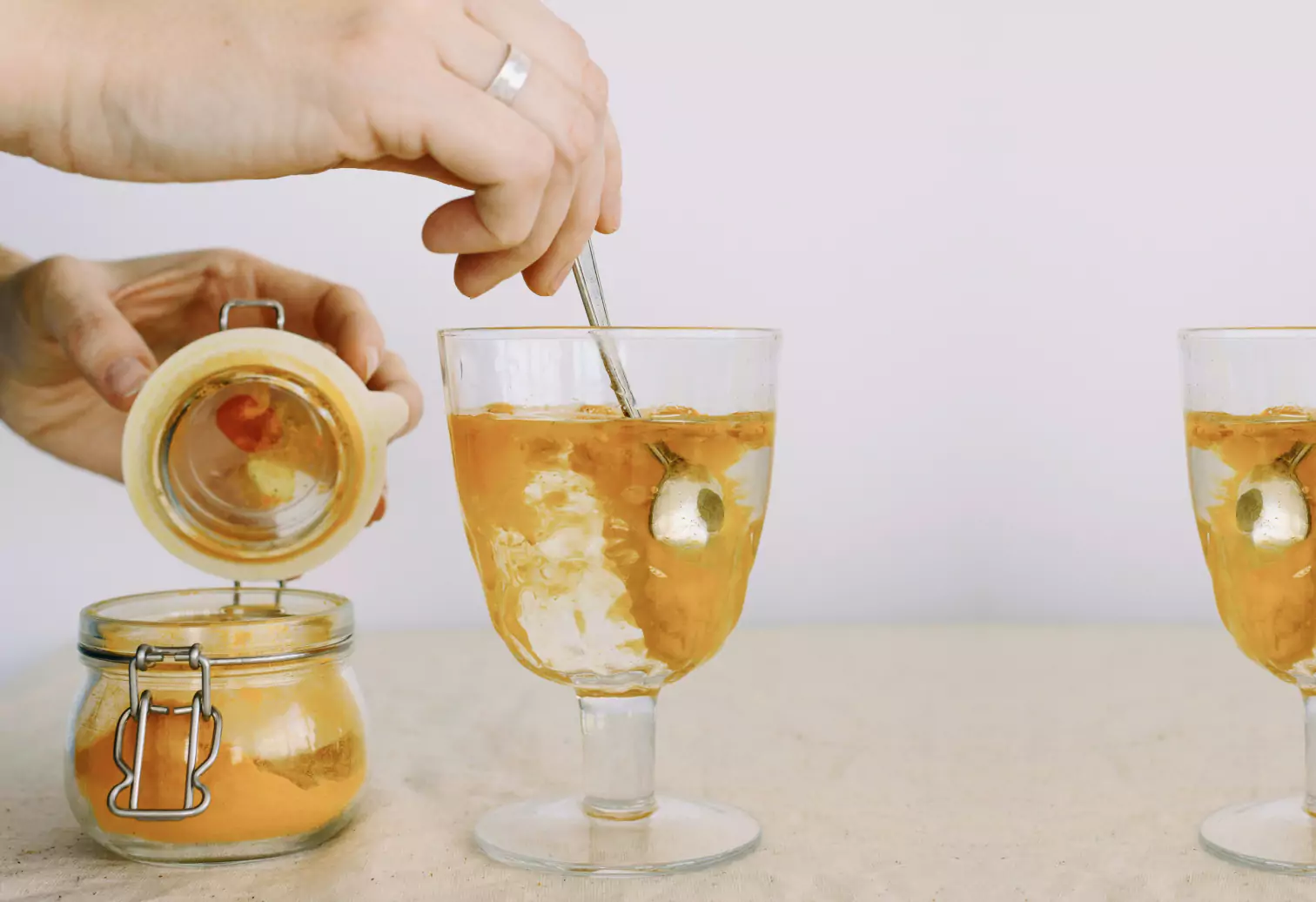 someone mixing turmeric into a drink