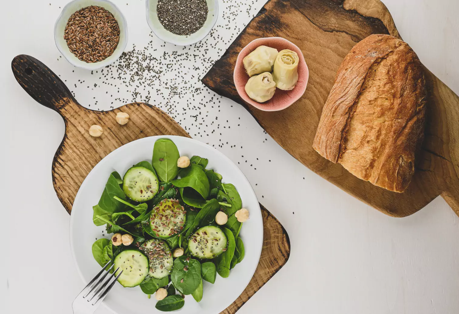 a plate of salad, bread, and seeds