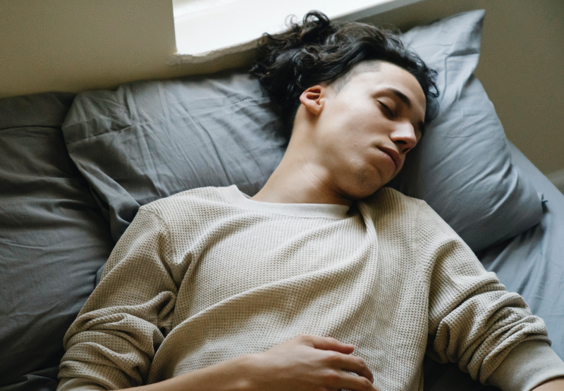 Person sleeping on bed