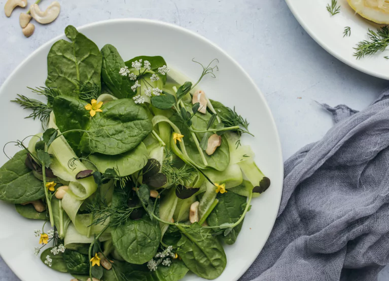 a bowl of greens on a plate