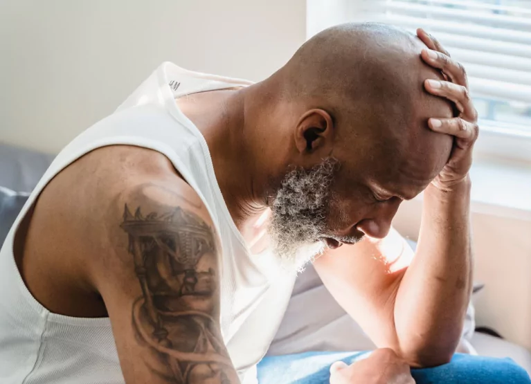a man holding his head and looking down