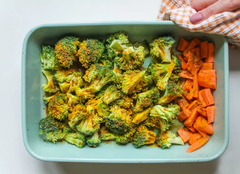 a dish full of seasoned broccoli and carrots