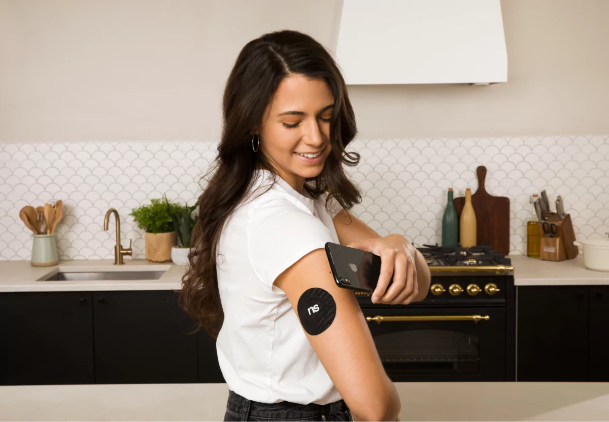 a woman scanning her nutrisense cgm