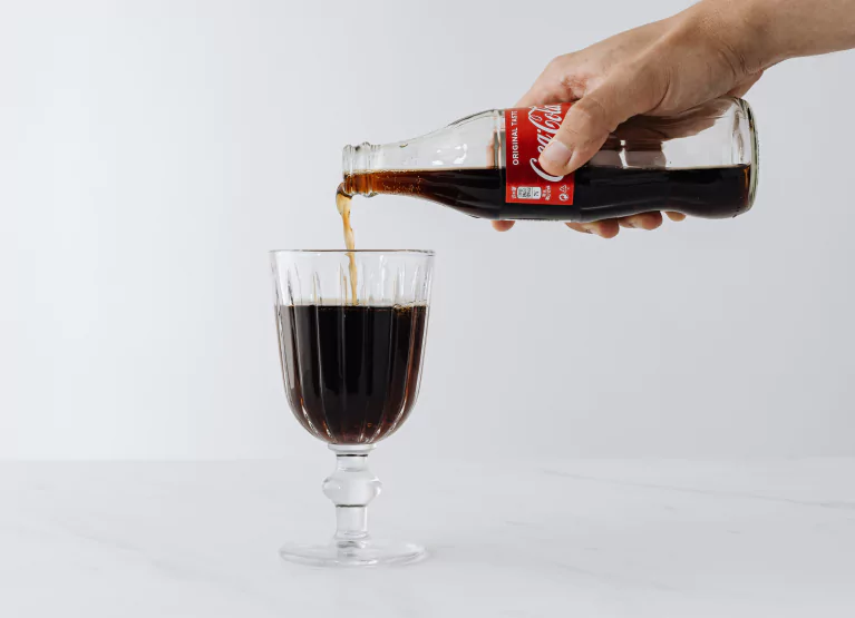 pouring a glass of coca cola